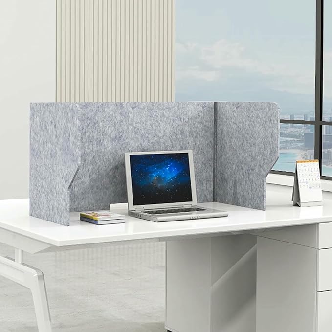 Acoustic desk dividers between workstations in modern office